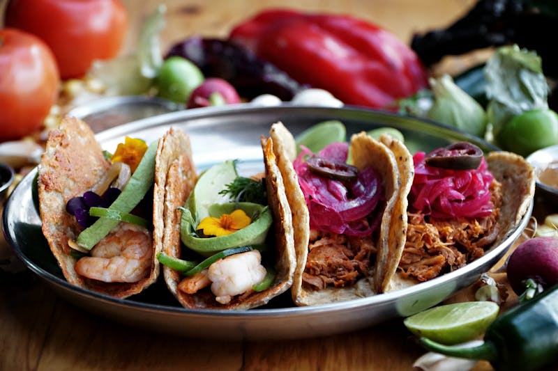 Grilled chicken platter with fresh vegetables and sauces